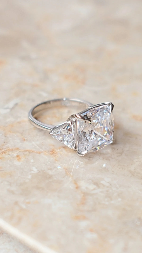 Detailed view of the Gemma trilogy ring's cushion cut facets and silver setting.