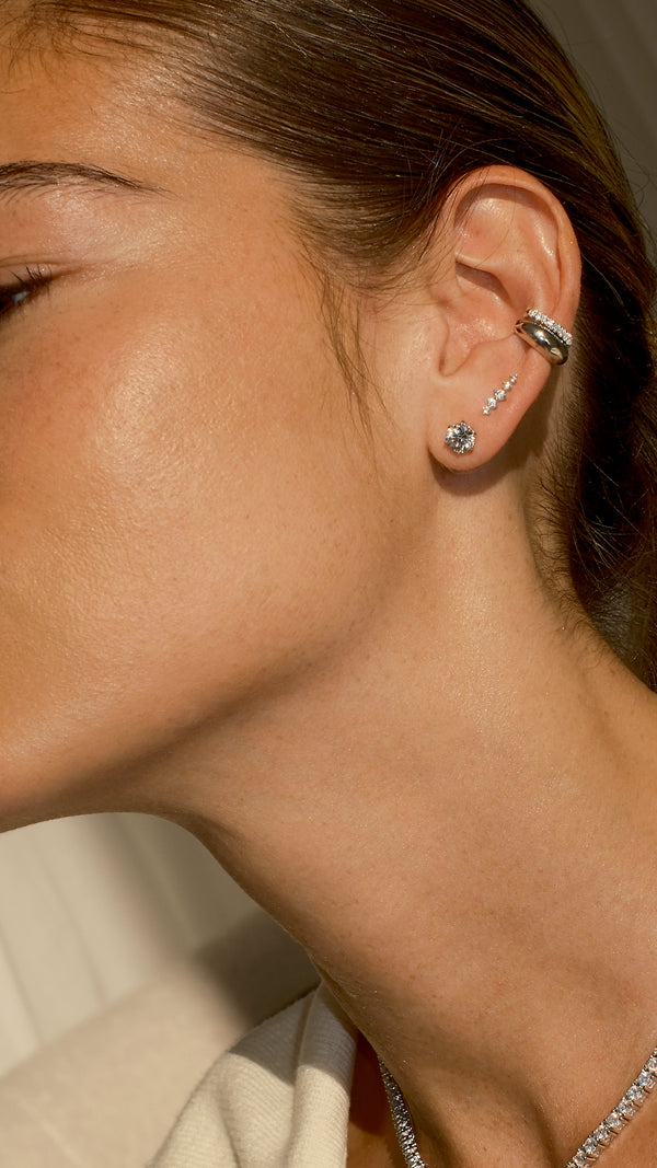 Side profile of a sterling silver earring stack with two studs and two stacked ear cuffs.