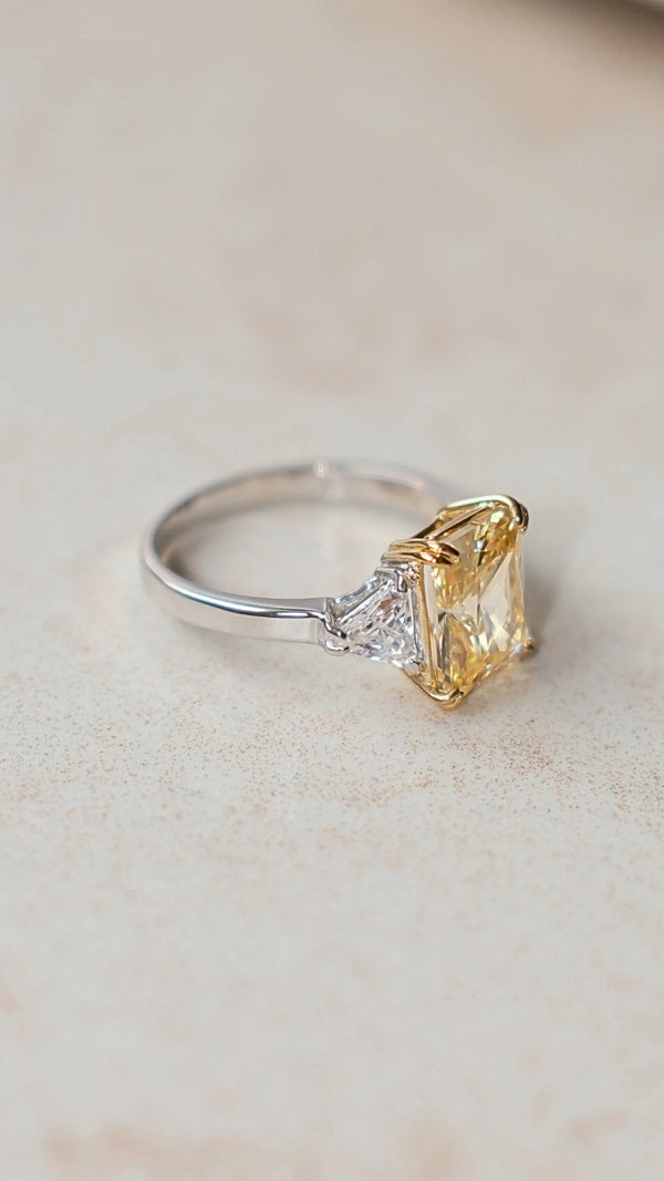 Close-up of triangle-cut side stones on a sterling silver radiant cut ring