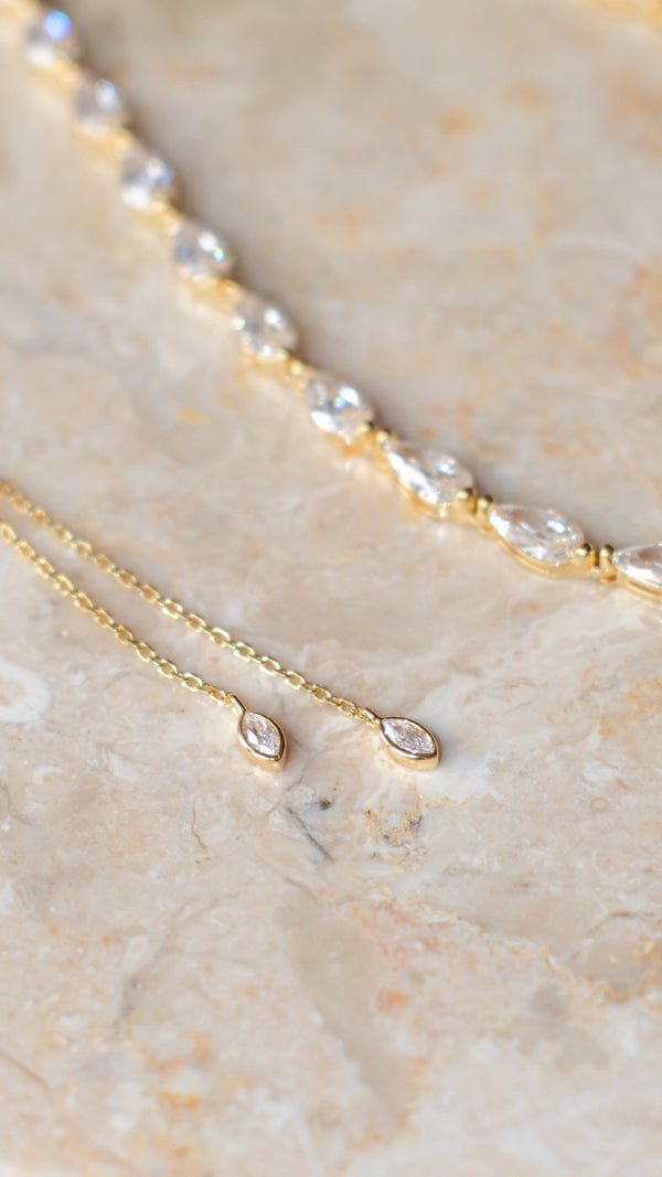 Detail of adjustable slider chain on 18k gold vermeil tennis necklace with marquise-tipped ends