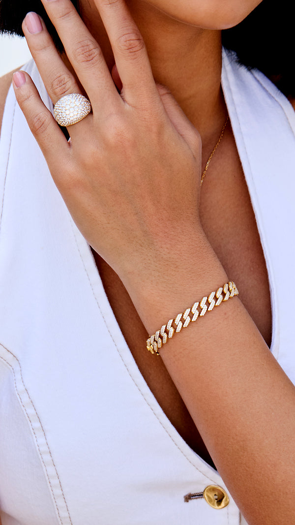 Sun hitting the gold vermeil and pavé gemstones on a model's wrist.
