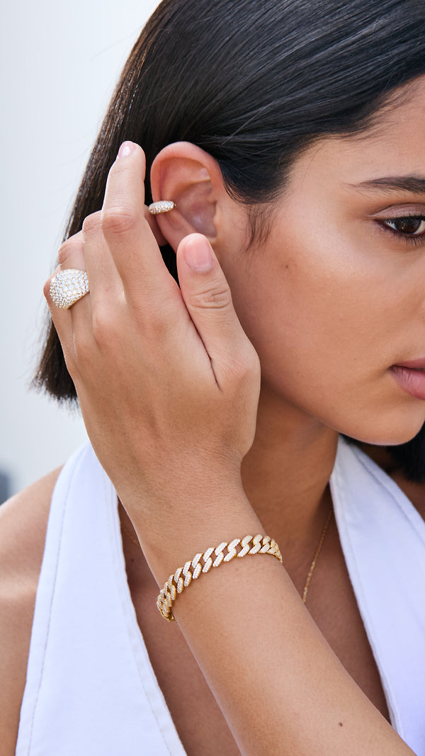 Model wearing the bold gold Vida Cuban chain bracelet with chunky dome pave ring.