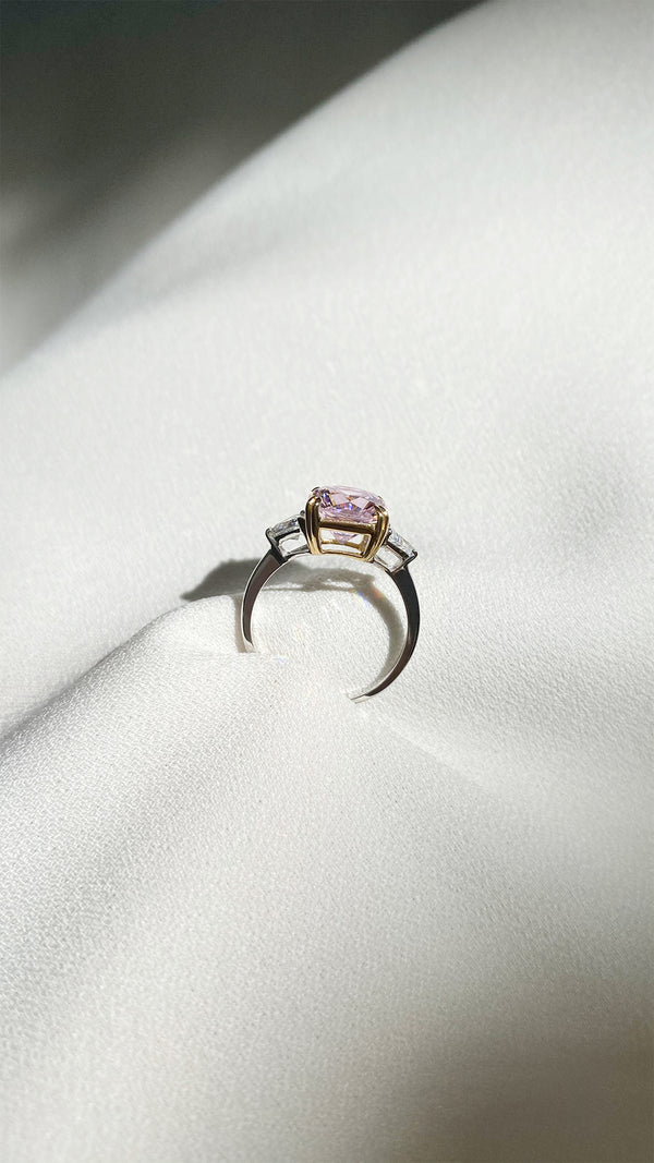 Side profile of a sterling silver baby cocktail ring, showcasing the secure double prong setting holding a 3ct equivalent fancy pink centre stone.