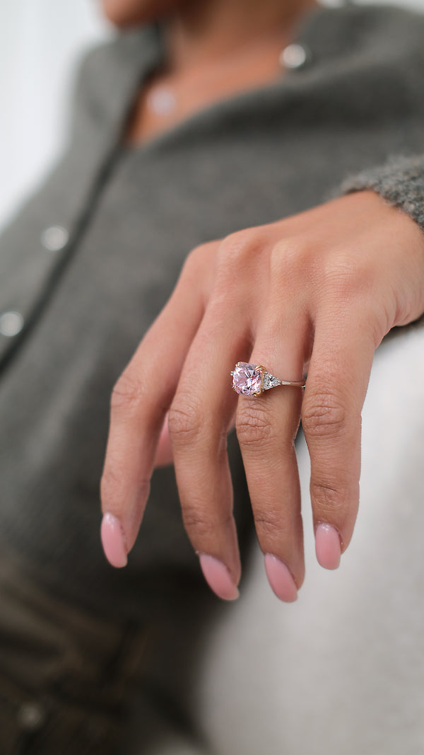 A sterling silver baby cocktail ring catching the natural sunlight to show off the 61 facets of its fancy pink Flanders cut centre stone.