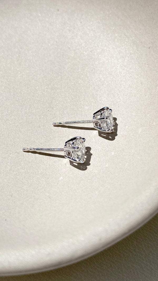 Side view of white gold simple stud earrings for women.