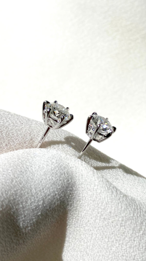 Close-up of round brilliant diamonds set in polished 18K white gold.