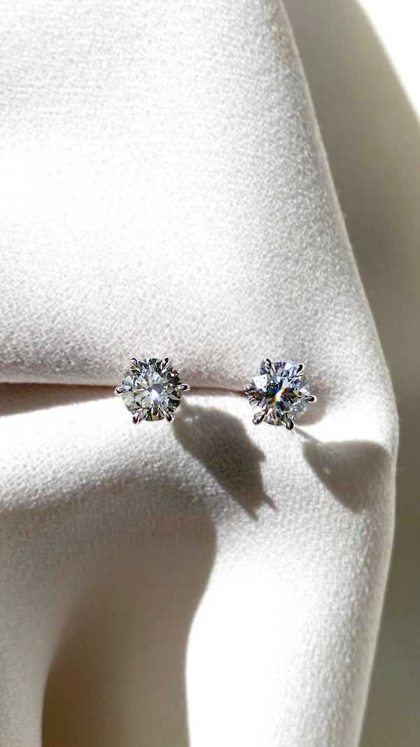 Six prong sparkling solid gold stud earring for women.